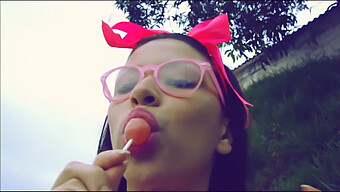 A Girl Enjoying A Popsicle While Giving Oral Pleasure